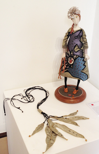PULLING ONE'S HAIR OUT (doll) by Wendy Anderson. 
       DRIFTING (necklace) by Gail Stahmer